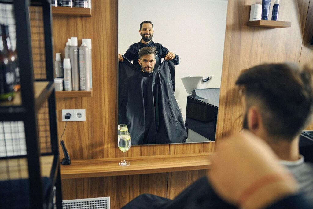 Estilista preparando al cliente para corte de pelo